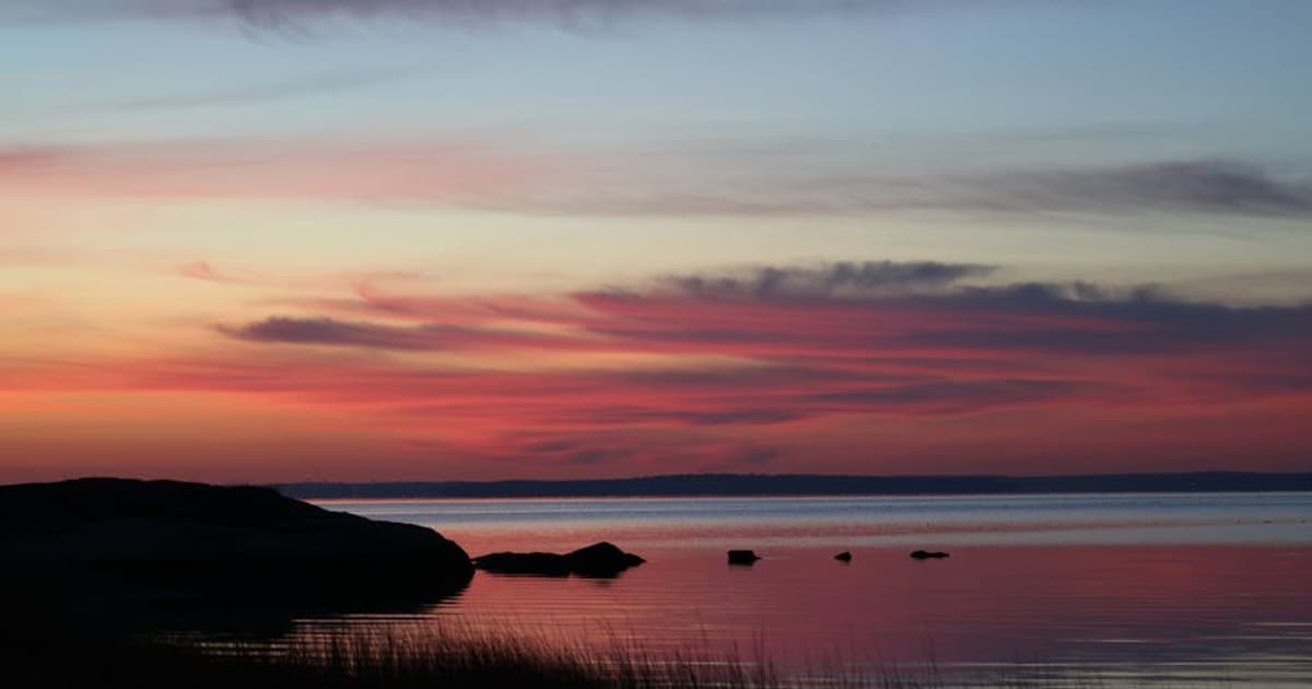 Stunning autumn sunrise with vivid colors over Cove Island Park, Stamford, Connecticut, creating a serene coastal scene.