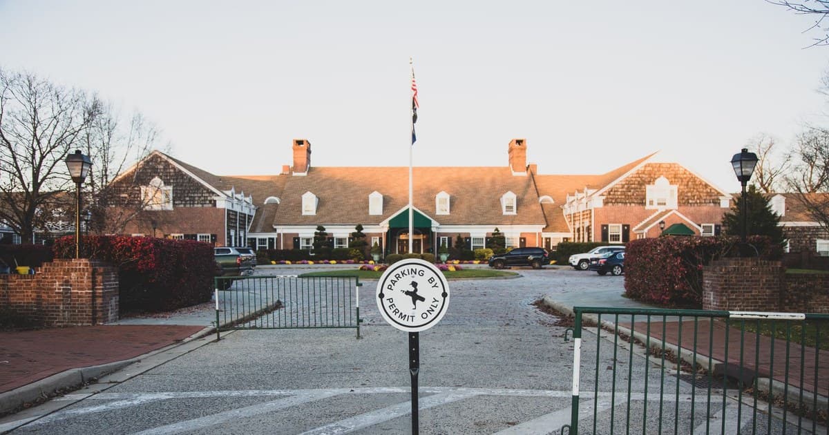 Cozy colonial-style brick building with parking sign, Farmingdale, NY